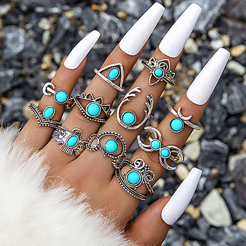 Turquoise Inlaid Carved Feather Ring Set: 8-piece ring set detail view