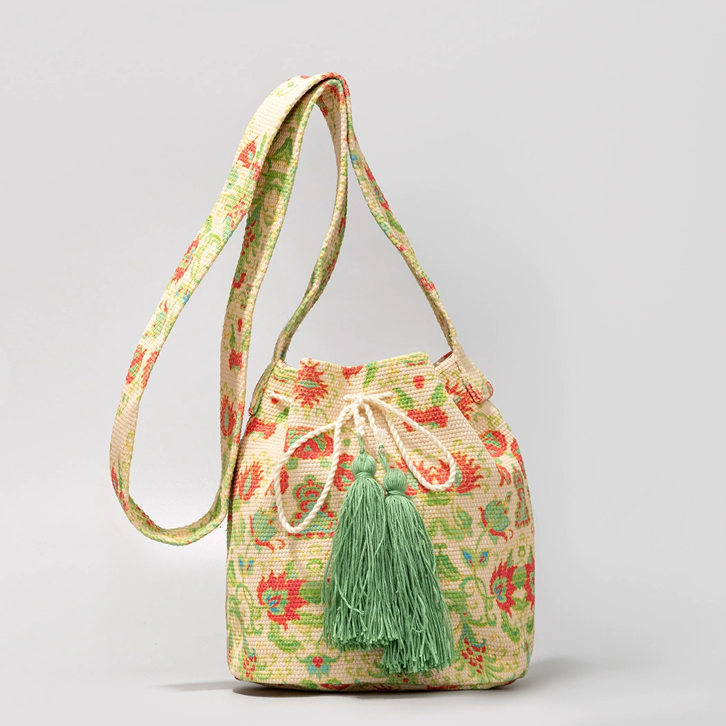 Colorful Woven Crossbody Bucket Bag at outdoor cafe